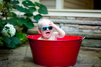 Baby sitting in a tub in Edina, MN for Newborn photographer