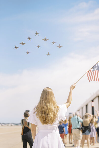 photo of a woman waving an American flag at a military homecoming in Virignia by Richmond photographer Jacqueline Aimee Portraits