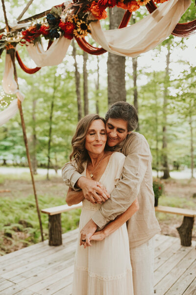 groom hugging bride from behind