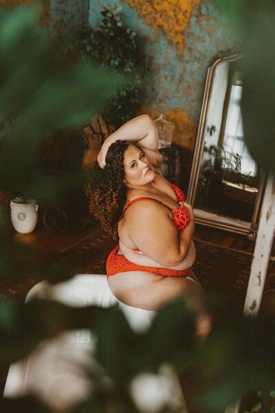 woman wearing a lingerie in front of a mirror