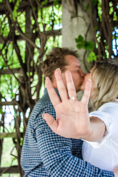 arizona couple kissing with engagement ring