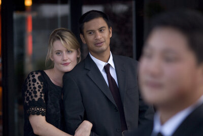 Two people with their arms linked at a wedding 
