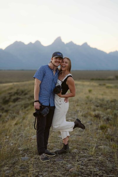 Lauren and Matt from Intimate Adventures Media standing in front of the Sawtooth mountain range in Stanley, Idaho