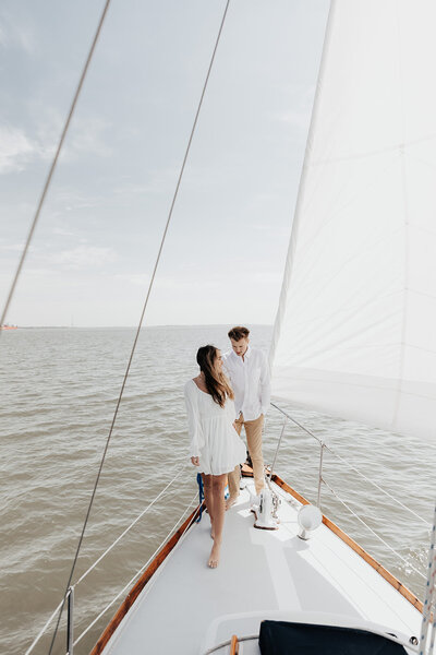 Charleston Engagement photo taken at the battery . Couple kissing with sun in background