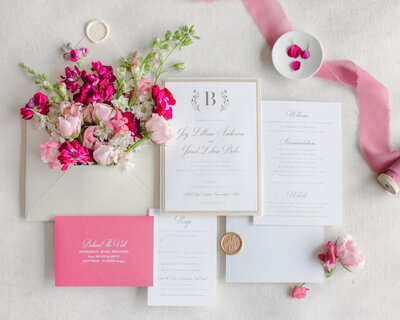 pink flatlay of invitation suite with pink florals
