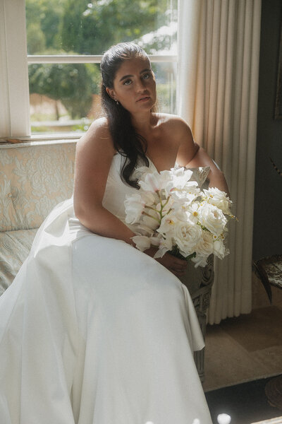 Bride in white dress and white gloves