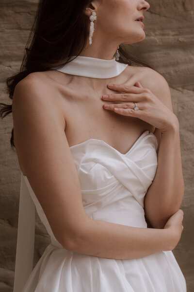 editorial bride posing with her hand on her chest