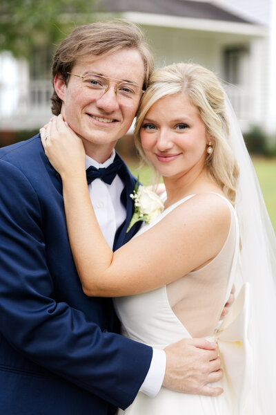 A newly married couple smile softly for their photographer