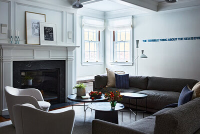 An interior designer in Boston MA creates a traditional brownstone with historic details and modern furniture, blending classic architecture with contemporary style.