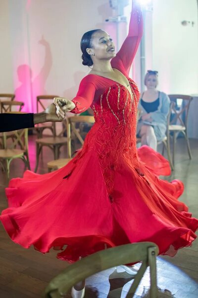 Morgan in red dress dancing for ballet competition
