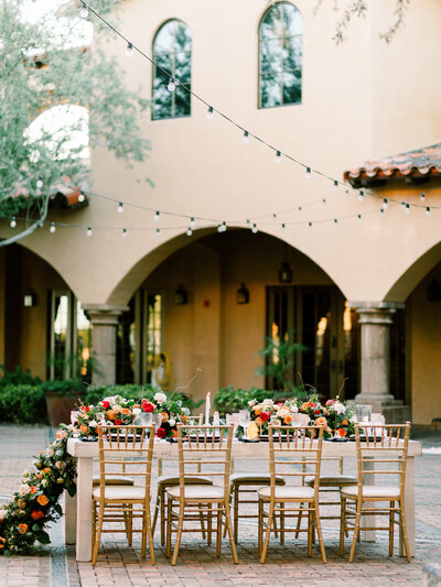 chairs set up at a wedding with a floral arrangement