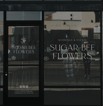 Branding for Knoxville florist Sugar Bee Flowers displayed on storefront windows, elegant typography