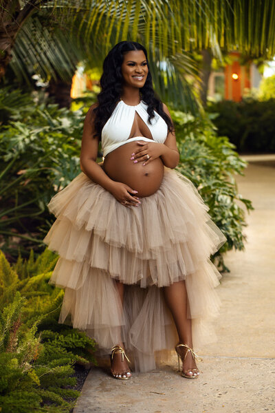 Cute pregnant woman models baby bump