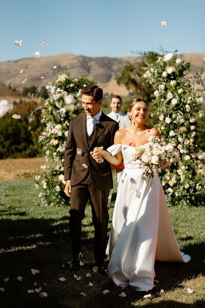 Wedding ceremony with lush flowers designed by San Luis Obispo wedding planner.