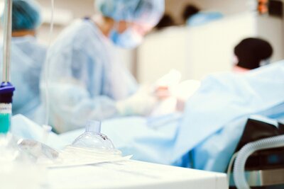breathing mask with surgeon in the background