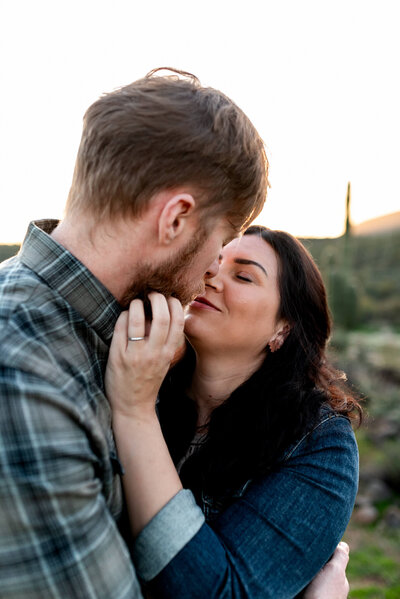 Couple touching noses intimately for a moment during a family photo session with Cactus & Pine Photography in Phoenix, Arizona
