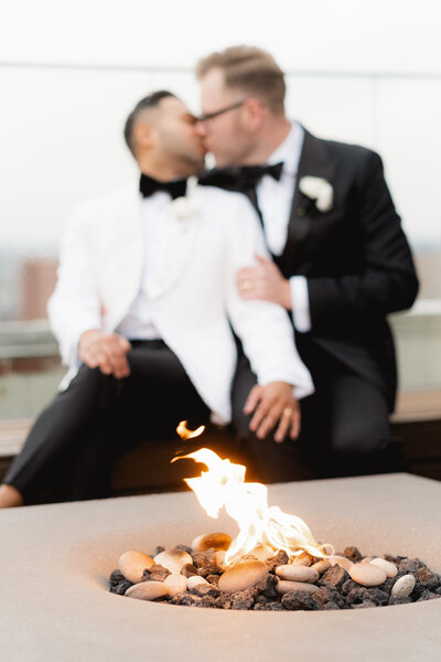 same sex couple kissing during photo on the rooftop terrace of the Hotel Kansas City