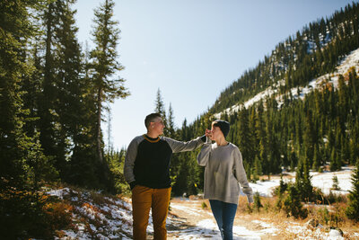 LGBTQ+ Couple in the snowy mountains during their Engagement Session with Tiny House Photo