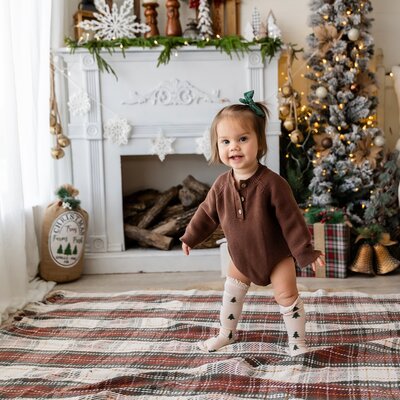 toddler standing with Christmas decor