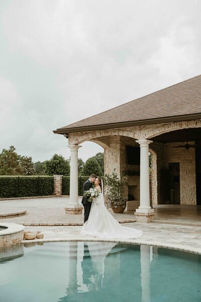 Bride and groom stand at their ceremony location overlooking the water in Switzerland, Florida.