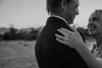 bride holds grooms shoulder in yuma wedding