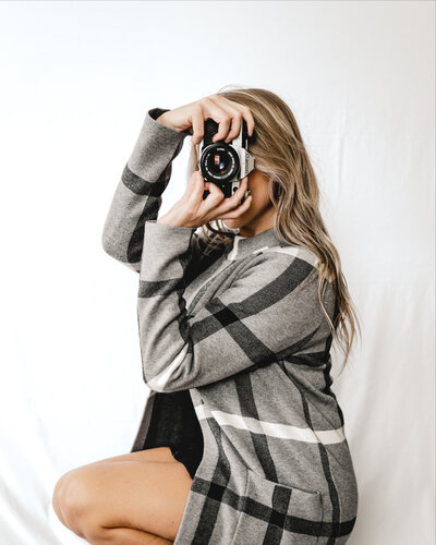 woman posing with film camera
