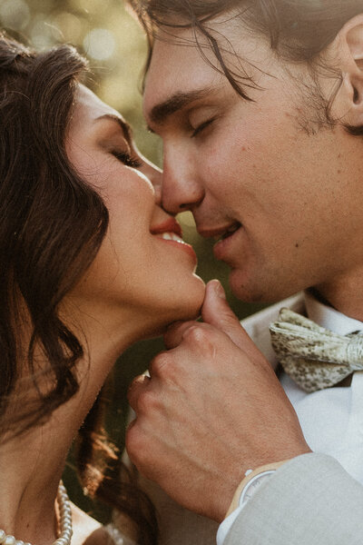 bride and groom going in for a kiss