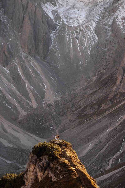 bride is holding grooms hand as she leads the way with mt rainier behind them
