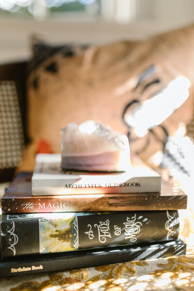 Spiritual books in pile in light room for Everything Ellemental