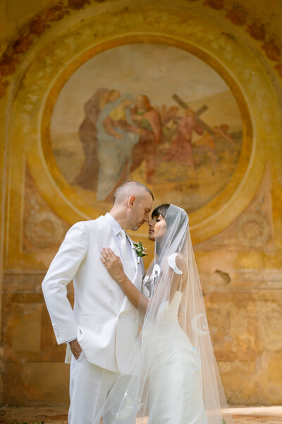 bride and groom at Villa Cetianle Tuscany in front of chapel