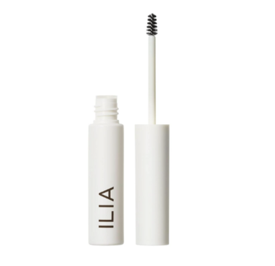 A minimalist white tube of ILIA brow gel with a spoolie wand applicator, positioned upright with the lid off. The clean design emphasizes natural beauty and effortless grooming.
