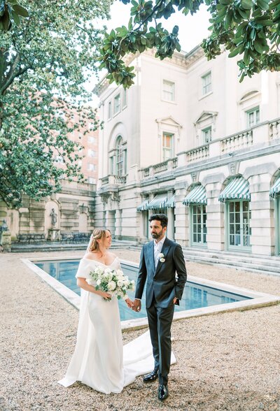 Wedding couple holding hands posing