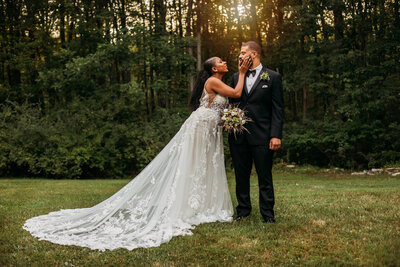 Bride touching her grooms face and staring into his eyes.