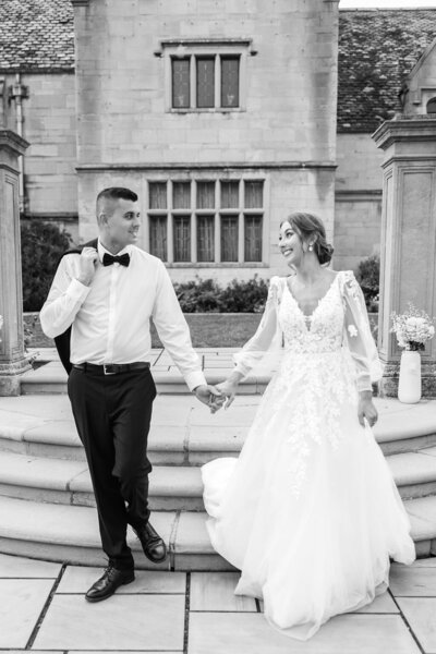 Photo of Bride and groom looking at each other walking to reception.