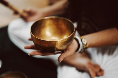 woman holding a gold bowl