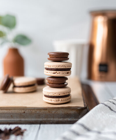 brown and cream colored macaroons stacked together