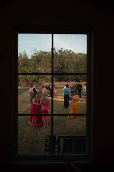 Candid photo during cocktail hour at La Bonne Vie Ranch in Kerrville, Texas
