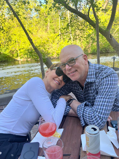 Melinda Fornero and husband Dan  hugging on a picnic table
