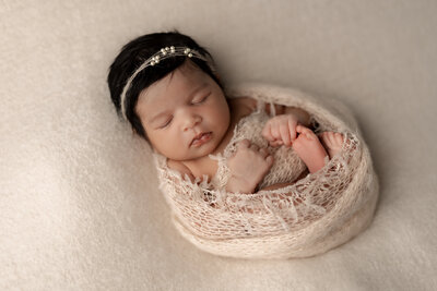 Newborn girl wrapped in pink at Kelly Adrienne Photography