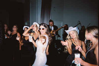 Flash photo of bride and bridesmaids dancing at reception