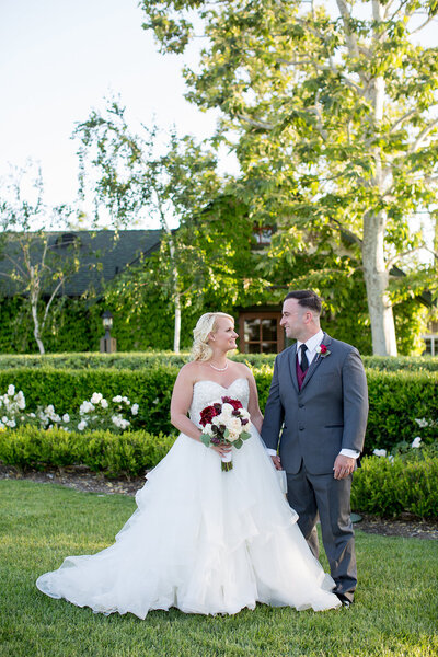 Bride and Groom standing in sunshine at their wedding at Ponte Winery