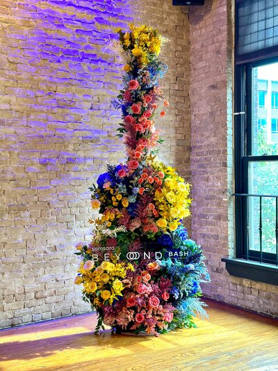 Large-scale floral installation for immersive Austin corporate event design, featuring bold colors and statement styling.