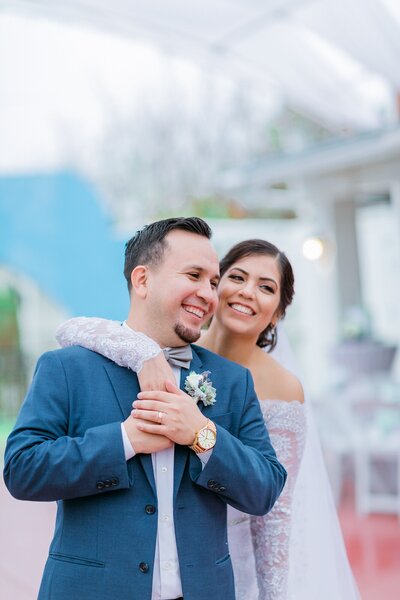 bride and groom smile at their wedding venue