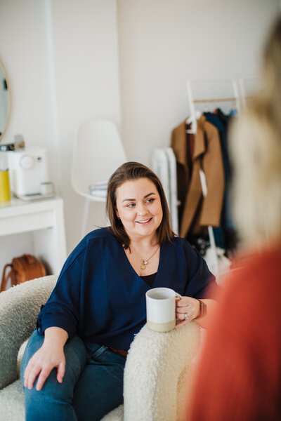 Picture of Bree smiling while leaning against a window sill
