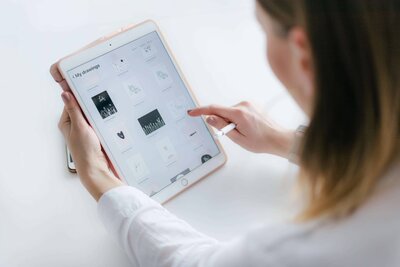 Woman scrolling through tablet