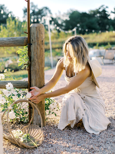 Fawn Renae admiring blooming white flowers