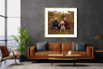 Framed artwork of a family with two dogs
