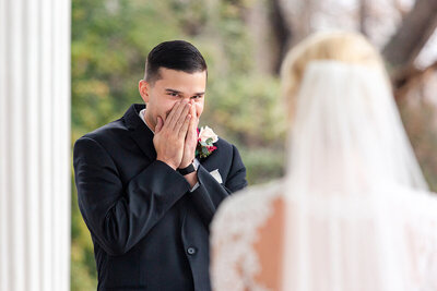Nick covers his mouth in joyful shock when he first sees his gorgeous bride in her wedding gown. It was a first look for the ages.