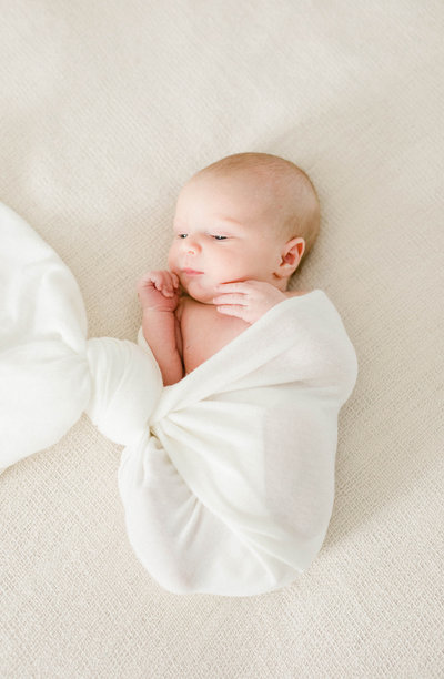 newborn baby wrapped in white cloth