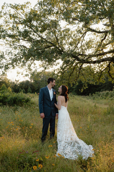 Photo of couple holding on to each other in a flower field during their elopement